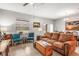 Cozy living area featuring tile floors, a comfortable couch, a ceiling fan, and plenty of natural light at 16930 Red Brick Ln, Land O Lakes, FL 34638