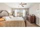 The sun-lit main bedroom has hardwood floors, a large bed, and decorative windows at 16930 Red Brick Ln, Land O Lakes, FL 34638