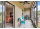 Cozy screened patio with seating, a grill, and sliding door access to the living room at 16930 Red Brick Ln, Land O Lakes, FL 34638