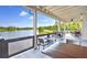 Covered patio offers scenic lake views, an ideal spot for outdoor dining at 16930 Red Brick Ln, Land O Lakes, FL 34638