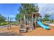 Community playground with slides, monkey bars, and play structure over mulch at 16930 Red Brick Ln, Land O Lakes, FL 34638