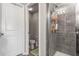 Bathroom with a tiled glass shower, white door and gray walls at 16930 Red Brick Ln, Land O Lakes, FL 34638