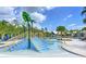 Community splash pad with water features, lounge chairs and tropical landscaping at 16930 Red Brick Ln, Land O Lakes, FL 34638