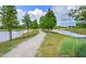 Scenic gravel walking path along the lake with lush green trees and stunning views at 16930 Red Brick Ln, Land O Lakes, FL 34638