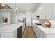 Elegant kitchen with stainless steel appliances, spacious quartz countertops, and sleek white cabinetry at 17030 Moonflower Dr, Venice, FL 34293