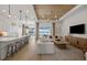 Open-concept living room featuring modern decor, wood floors, and a stunning water view at 17030 Moonflower Dr, Venice, FL 34293
