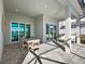 Covered patio overlooking lake with an outdoor dining area and comfortable seating at 17030 Moonflower Dr, Venice, FL 34293