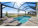 Relaxing screened-in pool and spa area with a beautiful waterfront view and comfortable lounge chairs at 17030 Moonflower Dr, Venice, FL 34293