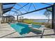 Screened-in pool and spa boasts a stone patio and tranquil waterfront views at 17030 Moonflower Dr, Venice, FL 34293