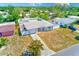 Aerial view of the charming single-story home with a well-maintained lawn and white fence in a sunny neighborhood at 1859 Northview Rd, Largo, FL 33770