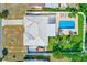Top-down aerial view of the property showcasing the pool, patio, outdoor grill, landscaping and fenced in yard at 1859 Northview Rd, Largo, FL 33770