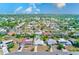 Aerial view showcases this homes location within a residential area, lush greenery, and mature trees at 1859 Northview Rd, Largo, FL 33770