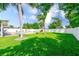 Beautifully landscaped backyard with a pool, patio, grill, and lush green grass, perfect for outdoor entertaining at 1859 Northview Rd, Largo, FL 33770