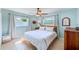 Cozy bedroom with a ceiling fan and soft, natural lighting from large windows at 1859 Northview Rd, Largo, FL 33770
