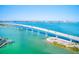 Aerial view of a long bridge spanning a body of turquoise water on a clear day with city views in the distance at 1859 Northview Rd, Largo, FL 33770