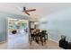 Inviting dining area with a wooden table and chairs, open to a sunroom at 1859 Northview Rd, Largo, FL 33770