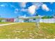 Charming single-story home with a well-maintained lawn, long driveway and white fence in a sunny neighborhood at 1859 Northview Rd, Largo, FL 33770