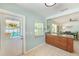 Open-concept kitchen with granite countertops and access to the pool area at 1859 Northview Rd, Largo, FL 33770