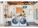 Modern laundry room features updated washer and dryer, sink and storage at 1859 Northview Rd, Largo, FL 33770