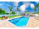 Sparkling private pool surrounded by a brick patio and lush landscaping perfect for outdoor living at 1859 Northview Rd, Largo, FL 33770