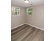 Bright bedroom with two windows and wood-look floors at 1914 53Rd S St, Gulfport, FL 33707