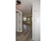Hallway with modern light fixture, showcasing wood-look flooring and access to other rooms at 1914 53Rd S St, Gulfport, FL 33707