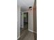 Hallway with contemporary lighting fixtures, wood-look flooring and view of the sun room at 1914 53Rd S St, Gulfport, FL 33707