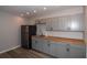 Kitchen features gray cabinets, butcher block counters and stainless refrigerator at 1914 53Rd S St, Gulfport, FL 33707