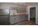 Kitchen features gray cabinets, butcher block counters and stainless refrigerator at 1914 53Rd S St, Gulfport, FL 33707