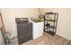 Functional laundry room featuring a washer, dryer, and storage shelving on attractive wood-look tile at 1914 53Rd S St, Gulfport, FL 33707