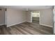 Open-concept living area with wood-style flooring and neutral walls, leading to a sunroom and a view of another room at 1914 53Rd S St, Gulfport, FL 33707