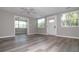 Bright, neutral living room showcasing new floors, fresh paint, and plenty of natural light from the multiple windows at 1914 53Rd S St, Gulfport, FL 33707
