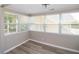 Cozy sun room featuring numerous windows, wood-look flooring and peaceful view at 1914 53Rd S St, Gulfport, FL 33707
