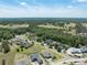 Expansive aerial view of a residential community with lush green spaces and a golf course at 19486 Sheltered Hill Dr, Brooksville, FL 34601