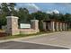 A stately entrance with brick columns and lush greenery welcomes residents and guests at 19486 Sheltered Hill Dr, Brooksville, FL 34601