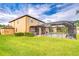 Well-maintained backyard with a screened-in pool and ample green space at 19533 Whispering Brook Dr, Tampa, FL 33647