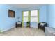 This bedroom has a large window, and features blue walls and carpet at 19533 Whispering Brook Dr, Tampa, FL 33647