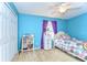 Bright bedroom with blue walls, carpet, a ceiling fan, and a large window at 19533 Whispering Brook Dr, Tampa, FL 33647