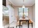 Cozy dining area with a wooden table, wicker chairs, and a view of the screened patio at 19533 Whispering Brook Dr, Tampa, FL 33647