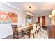 Elegant dining room featuring a dark wood table and decorative light fixture at 19533 Whispering Brook Dr, Tampa, FL 33647