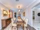 Elegant dining room with a long wooden table, seating for eight, and stylish sideboard with lamps at 19533 Whispering Brook Dr, Tampa, FL 33647