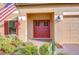 Charming entryway featuring a red double-door entry and manicured landscaping at 19533 Whispering Brook Dr, Tampa, FL 33647