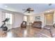 Spacious living room with hardwood floors, leather furniture, and large windows at 19533 Whispering Brook Dr, Tampa, FL 33647