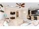 Open-concept living room with a large sectional sofa and seamless flow to the kitchen at 19533 Whispering Brook Dr, Tampa, FL 33647