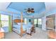 Bright bedroom with four poster bed, blue walls, and a beautiful tray ceiling at 19533 Whispering Brook Dr, Tampa, FL 33647