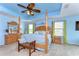 Light-filled main bedroom with a cozy sitting area and large windows at 19533 Whispering Brook Dr, Tampa, FL 33647