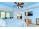 Light blue main bedroom featuring a four-poster bed, and ensuite bath at 19533 Whispering Brook Dr, Tampa, FL 33647