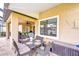 Covered patio features an outdoor dining area with stylish furniture and views of the surrounding landscape at 19533 Whispering Brook Dr, Tampa, FL 33647