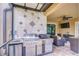 Outdoor kitchen with a stainless steel grill, sink, and granite countertops, perfect for entertaining at 19533 Whispering Brook Dr, Tampa, FL 33647