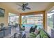 Covered patio with a ceiling fan, offering a relaxing view of the backyard pool area at 19533 Whispering Brook Dr, Tampa, FL 33647